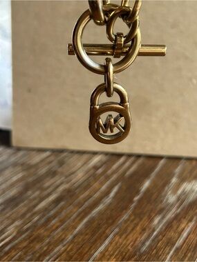 Michael Kors Gold color chunky Link Chain Bracelet with MK Toggle/Charm